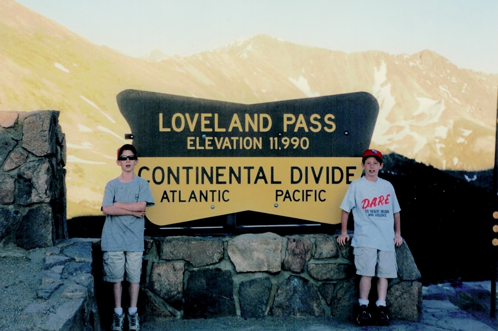 Matt Convente and Mike Convente posing next to the Loveland Pass Continental Divide sign.